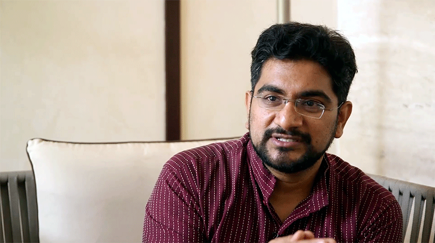 Preview image for the video "Alumni Changemaker: Madhukar Banuri, Teach For India, 2009" - Close up headshot of a young Indian man with a short beard in a maroon shirt.