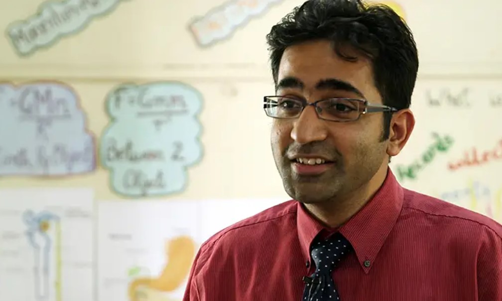 Preview image for the video "Alumni Changemaker: Soumya Jain, Founder &amp; CEO, iTeach Schools" - Headshot of a young Indian man with brown hair and glasses in a shirt and tie.