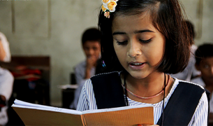 A young indian girl reads a book