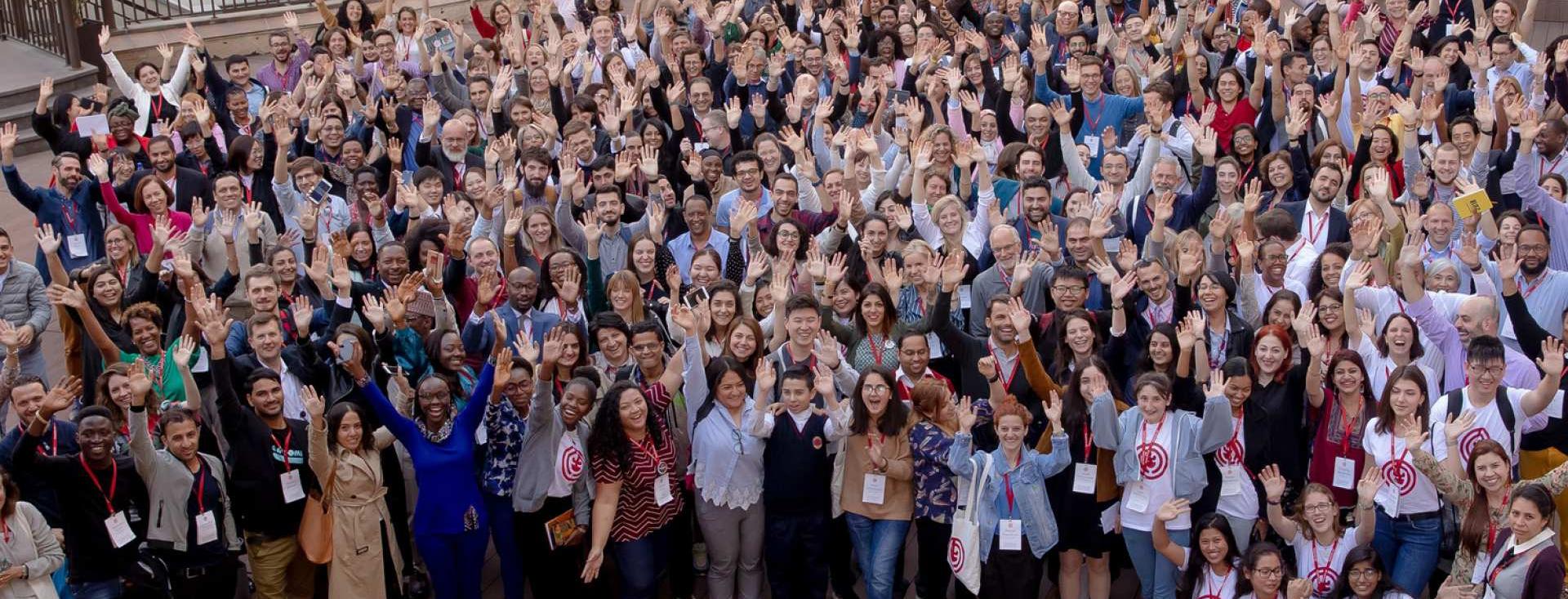 Large group of people waving at the camera