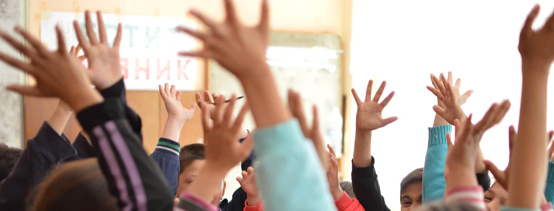 A Teach for All Bulgaria teacher engaging with students in a bright classroom for the FIERST project.