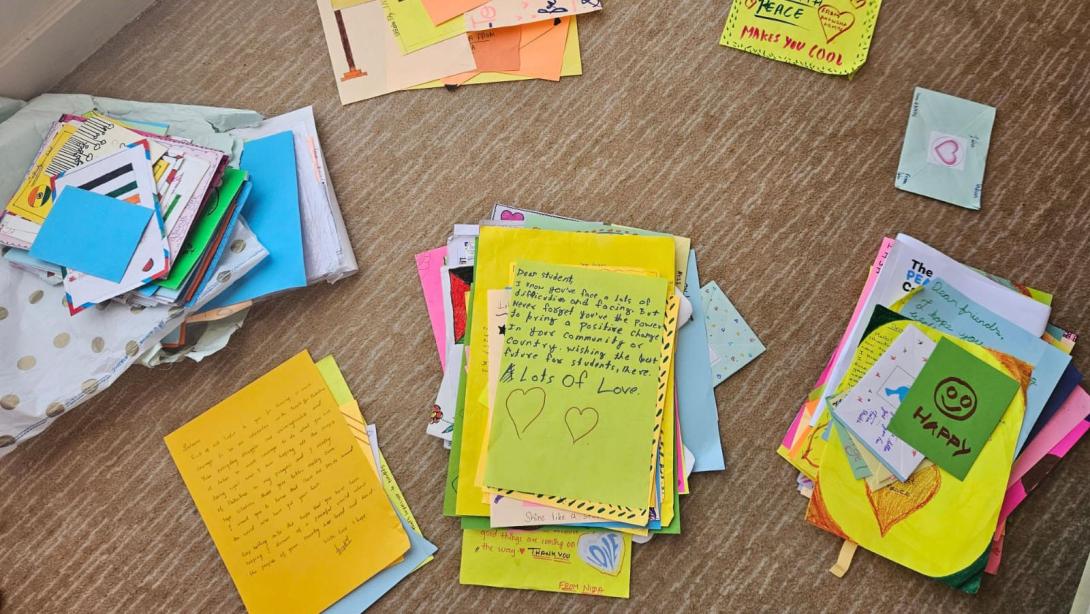 Piles of handwritten letters on colored paper